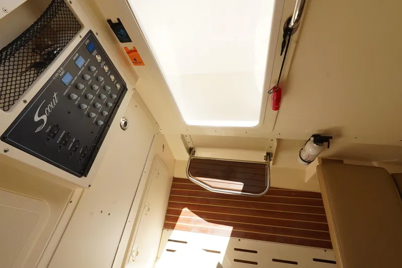 Slide: The Image of Interior of 2017 Scout 300 LXF boat with control panel and wooden flooring. - 33