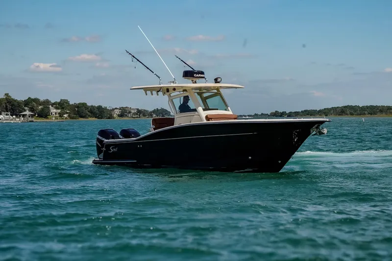 Slide: The Image of 2017 Scout 300 LXF boat cruising on a sunny day. - 4