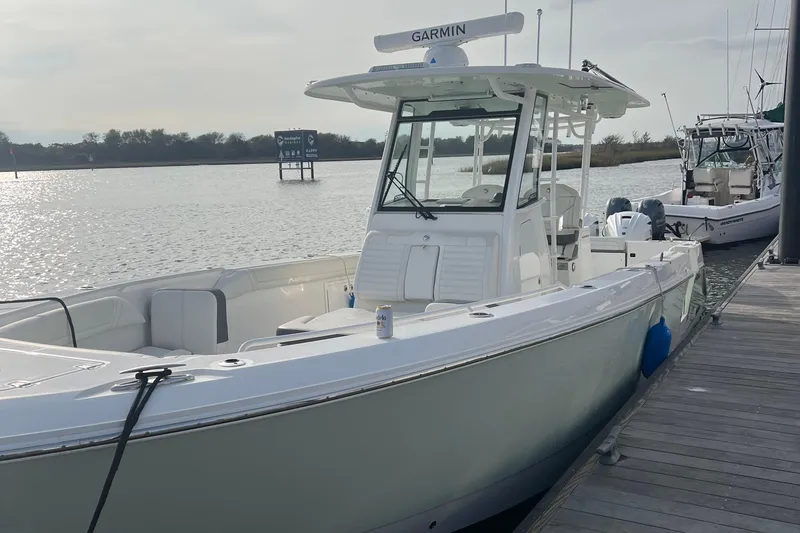 Slide: The Image of 2020 Edgewater 340CC boat docked by the water with Garmin equipment. - 7
