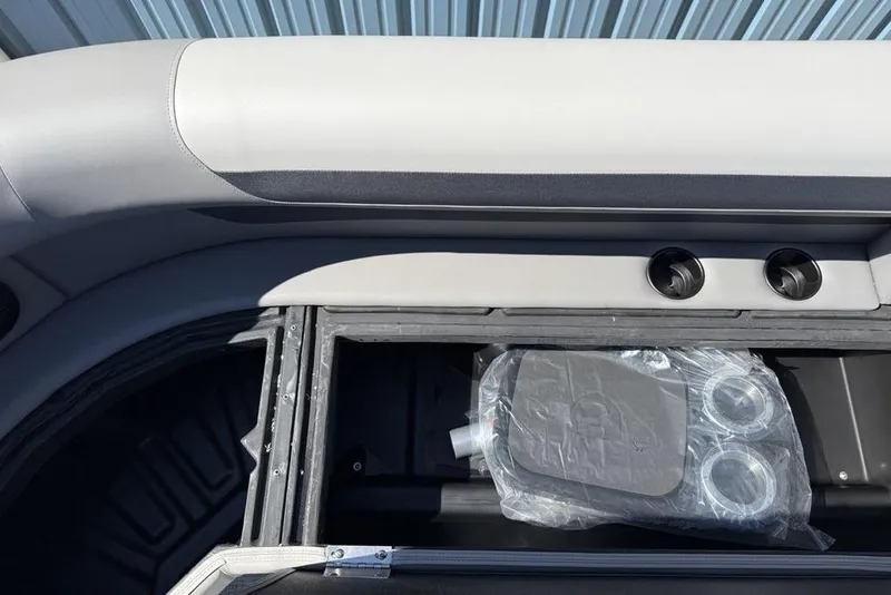 Slide: The Image of 2026 Premier 220 SUNSCAPE RL boat interior storage compartment with cup holders. - 12