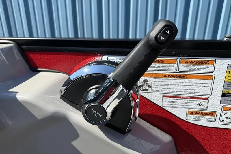 Slide: The Image of Throttle control lever on 2026 Premier 220 SUNSCAPE RL boat, with warning labels in background. - 13