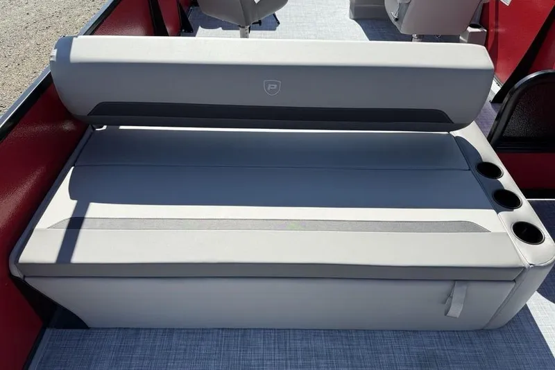 Slide: The Image of 2026 Premier 220 SUNSCAPE RL boat seat with cup holders, gray upholstery, and red accents. - 20