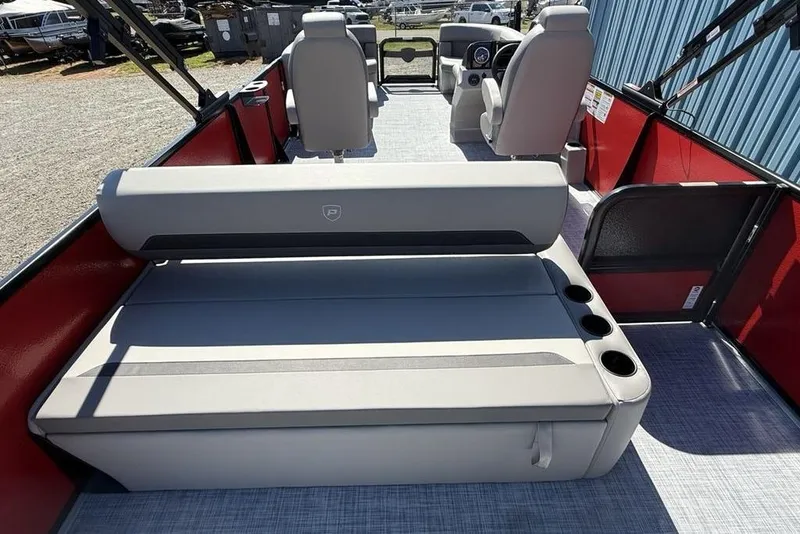 Slide: The Image of 2026 Premier 220 SUNSCAPE RL boat interior with gray seating and cup holders. - 22