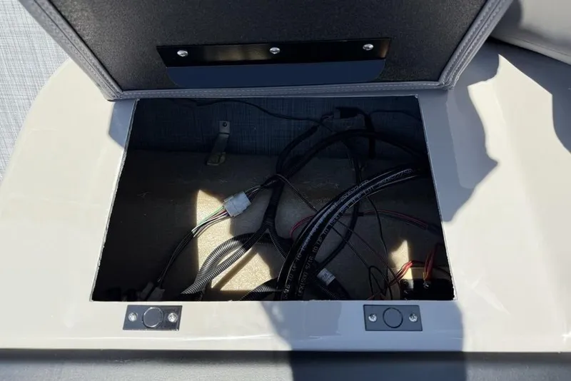 Slide: The Image of Open storage compartment with wiring in a 2026 Premier 220 SUNSCAPE RL boat. - 9