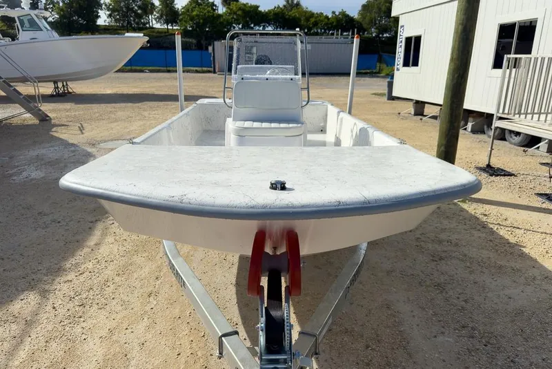 Slide: The Image of 2026 Coastal Skiff 171 boat on trailer in outdoor setting. - 12