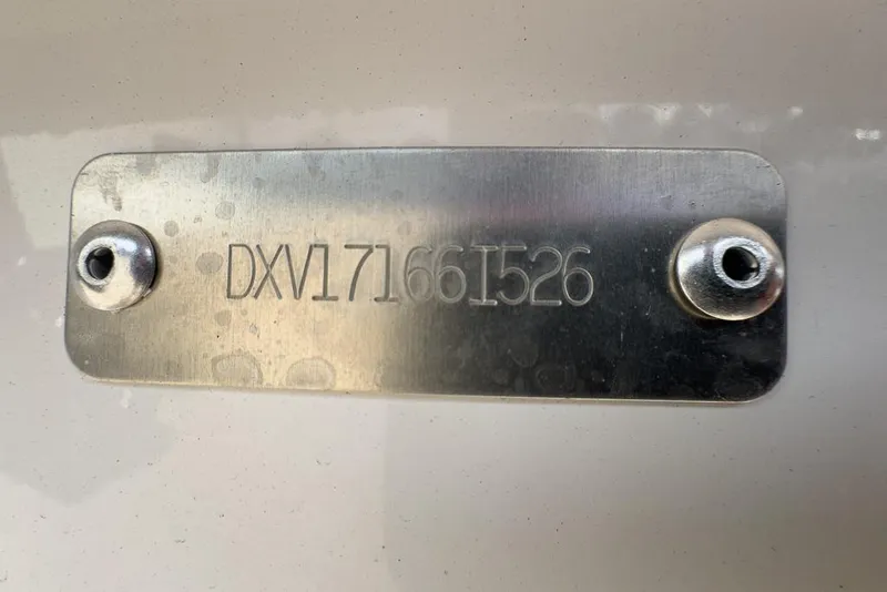 Slide: The Image of Metal identification plate on a 2026 Coastal Skiff 171 boat. - 14