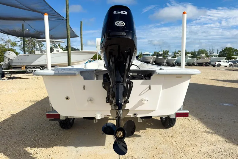 Slide: The Image of 2026 Coastal Skiff 171 boat with 60 HP outboard motor, parked on a trailer. - 4