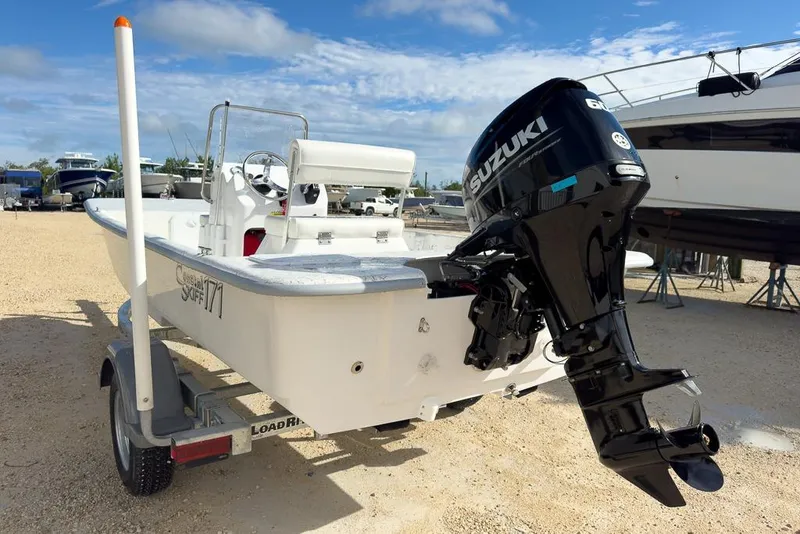 Slide: The Image of 2026 Coastal Skiff 171 boat with Suzuki outboard motor on trailer. - 5