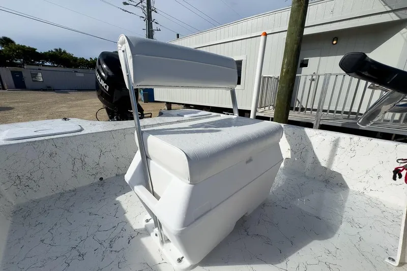 Slide: The Image of 2026 Coastal Skiff 171 boat interior with white seating and marbled flooring. - 9