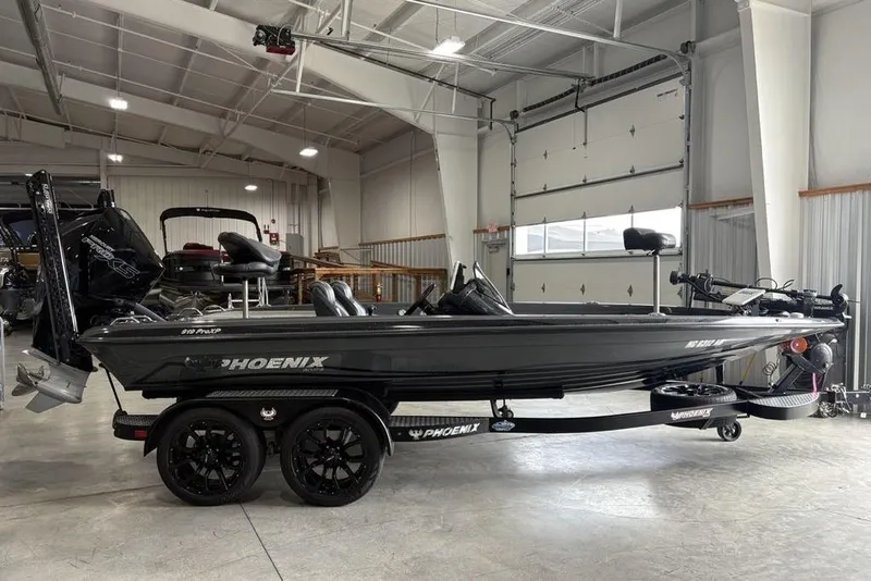 Slide: The Image of 2024 Phoenix 919 Pro XP boat in a spacious indoor showroom. - 1