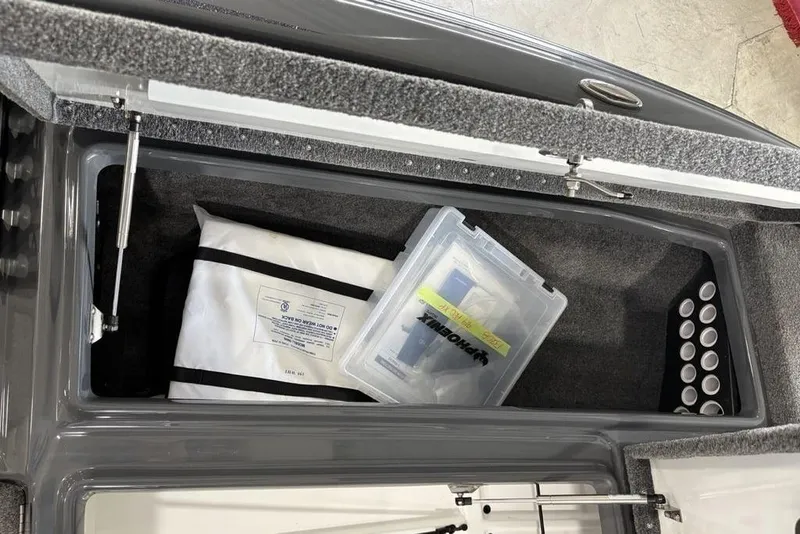 Slide: The Image of Storage compartment of 2024 Phoenix 919 Pro XP boat with organized gear and accessories. - 11