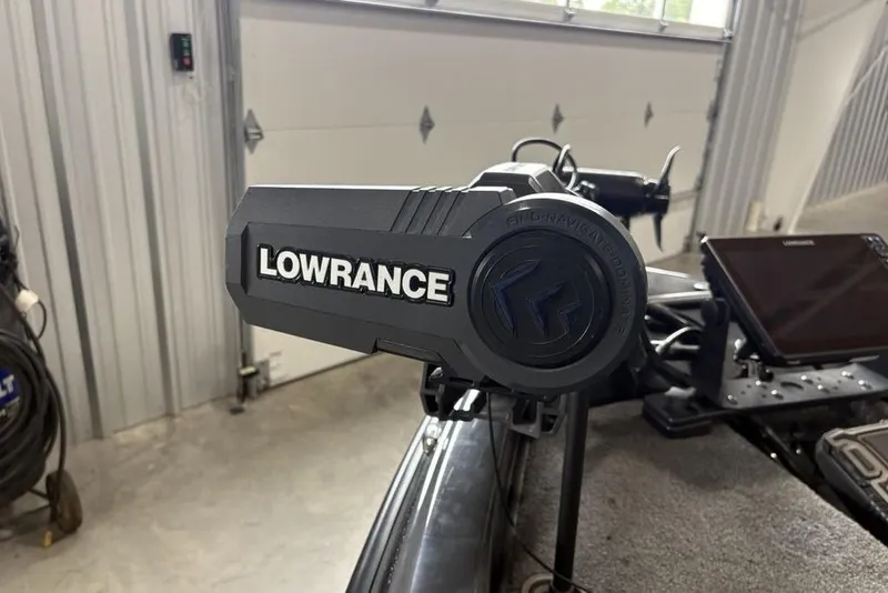 Slide: The Image of Lowrance equipment on 2024 Phoenix 919 Pro XP boat in a garage setting. - 12
