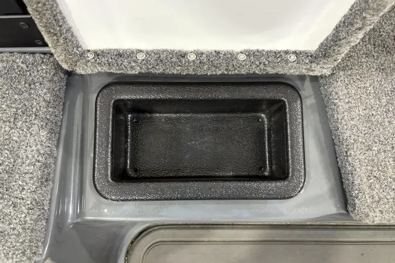 Slide: The Image of 2024 Phoenix 919 Pro XP boat storage compartment with gray carpeted interior. - 14