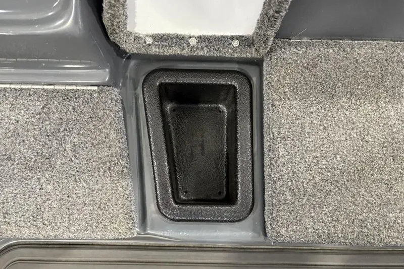 Slide: The Image of 2024 Phoenix 919 Pro XP boat interior with gray carpet and storage compartment. - 17