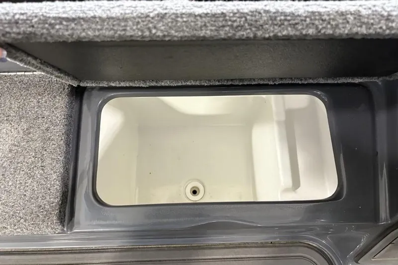 Slide: The Image of Open storage compartment in 2024 Phoenix 919 Pro XP boat. - 18
