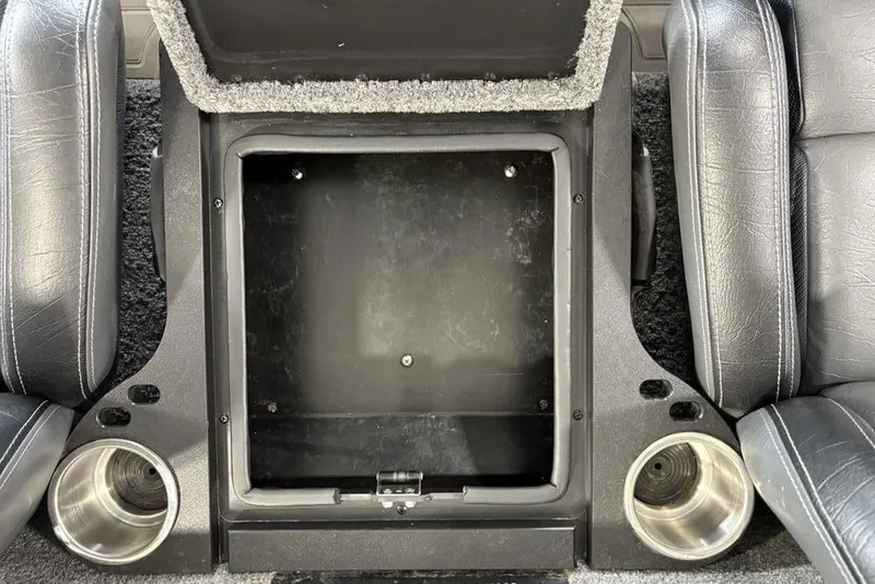 Slide: The Image of 2024 Phoenix 919 Pro XP interior storage compartment with cup holders and leather seats. - 19