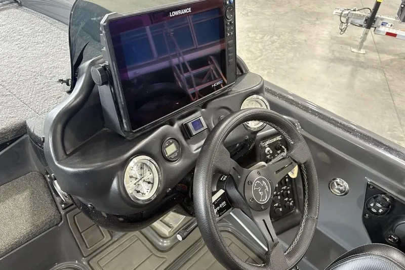 Slide: The Image of 2024 Phoenix 919 Pro XP boat dashboard with Lowrance display and steering wheel. - 21