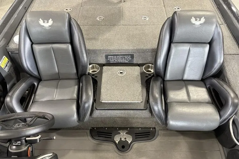 Slide: The Image of 2024 Phoenix 919 Pro XP boat interior with dual leather seats and steering wheel. - 23