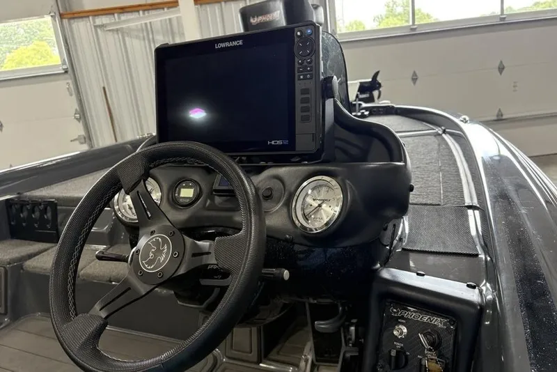 Slide: The Image of 2024 Phoenix 919 Pro XP boat dashboard with steering wheel and Lowrance display. - 30