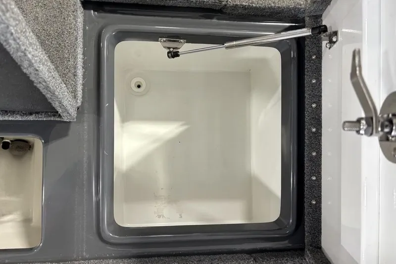 Slide: The Image of 2024 Phoenix 919 Pro XP boat storage compartment with latch and hydraulic support. - 33