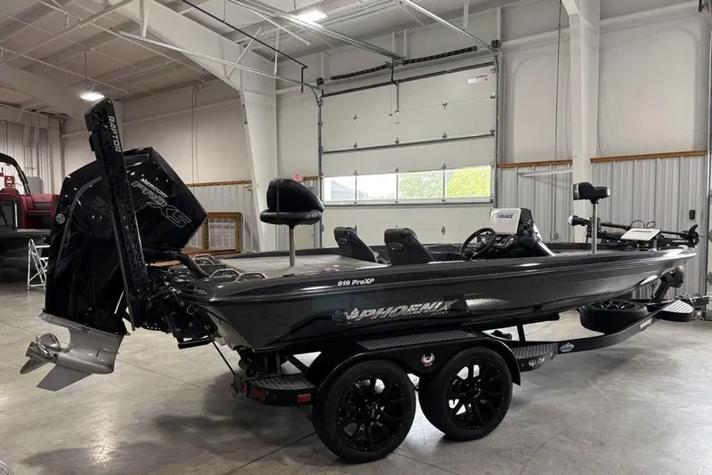 Slide: The Image of 2024 Phoenix 919 Pro XP boat in a garage, showcasing sleek design and powerful engine. - 4