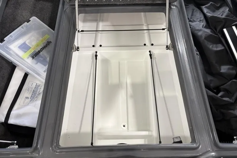 Slide: The Image of Open storage compartment of 2024 Phoenix 919 Pro XP boat, featuring organized interior space. - 8