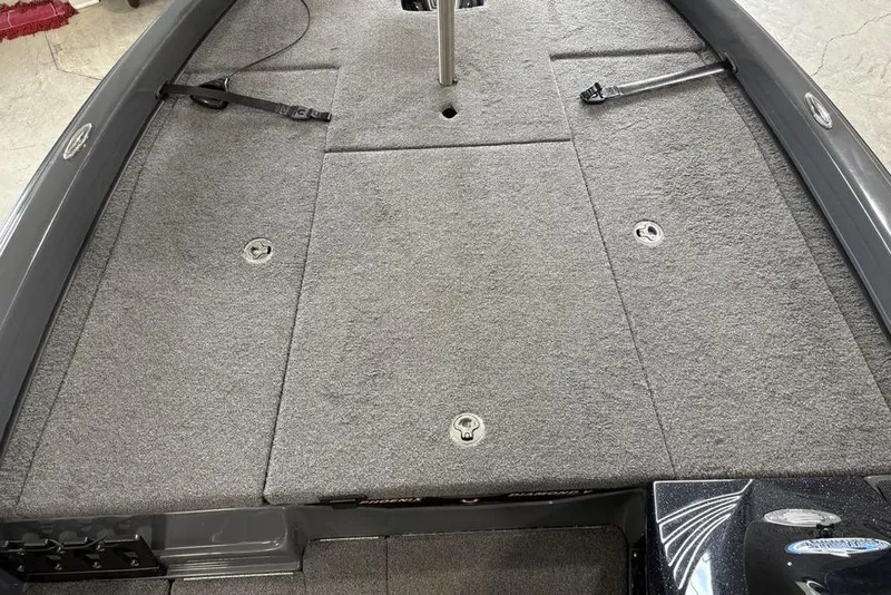 Slide: The Image of 2024 Phoenix 919 Pro XP boat deck with gray carpet and storage compartments. - 9