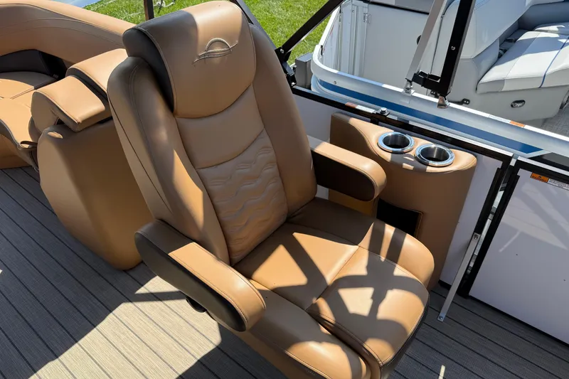 Slide: The Image of Luxurious tan seating on 2025 SunCatcher Fusion 324RC boat with cup holders. - 3