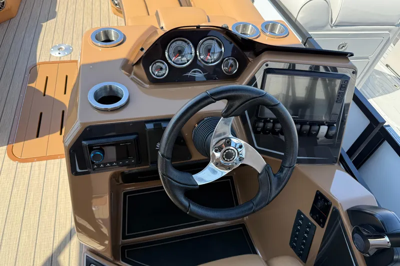 Slide: The Image of Steering console of 2025 SunCatcher Fusion 324RC boat with gauges and controls. - 5