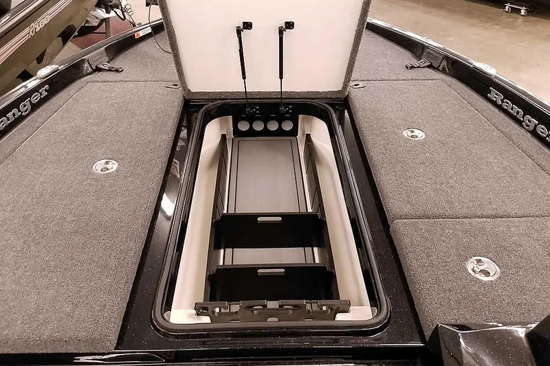 Slide: The Image of 2025 Ranger Z185 Z Pack boat storage compartment with open lid and organized interior. - 14