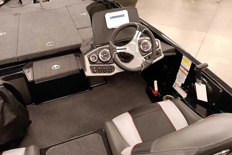 Slide: The Image of 2025 Ranger Z185 Z Pack boat interior with steering wheel and dashboard controls. - 23