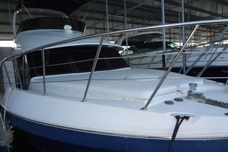 Slide: The Image of 2008 Bluewater 5200 Signature Edition yacht docked in a covered marina. - 10