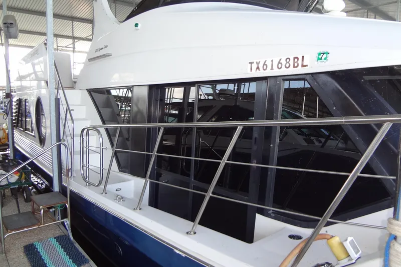 Slide: The Image of 2008 Bluewater 5200 Signature Edition yacht docked, featuring sleek design and modern amenities. - 12