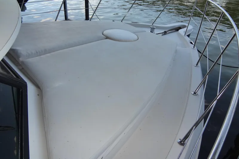 Slide: The Image of 2008 Bluewater 5200 Signature Edition yacht deck with railing, on calm water. - 13