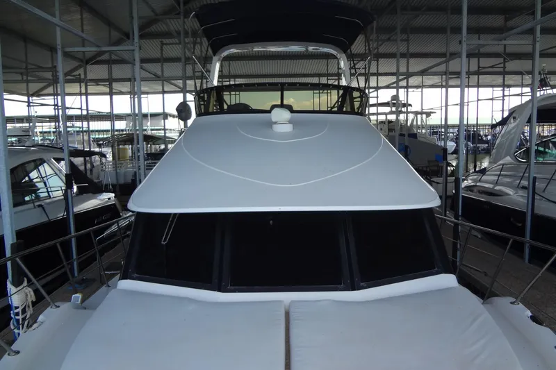 Slide: The Image of 2008 Bluewater 5200 Signature Edition yacht docked in a marina. - 17