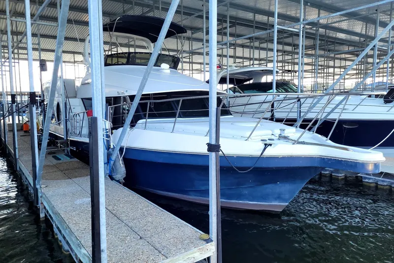 Slide: The Image of 2008 Bluewater 5200 Signature Edition yacht docked in a covered marina. - 2