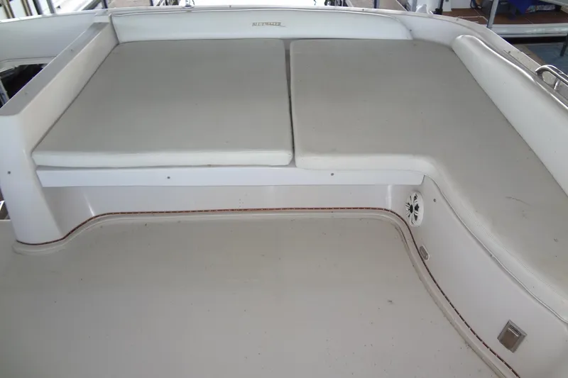 Slide: The Image of 2008 Bluewater 5200 Signature Edition boat seating area with white cushions. - 21
