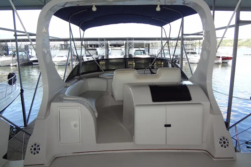 Slide: The Image of 2008 Bluewater 5200 Signature Edition yacht docked in a marina, featuring spacious seating. - 22