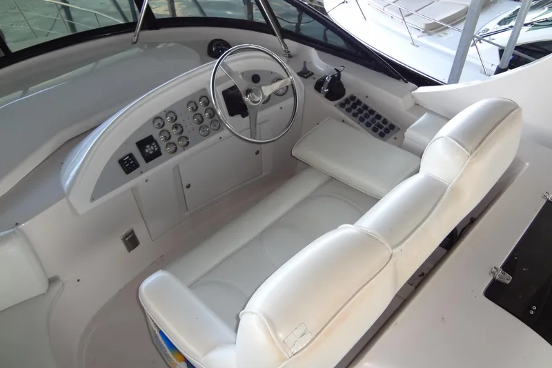 Slide: The Image of 2008 Bluewater 5200 Signature Edition helm with white leather seating and control panel. - 23