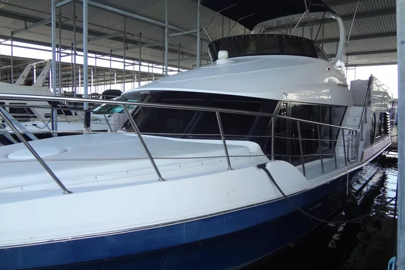 Slide: The Image of 2008 Bluewater 5200 Signature Edition yacht docked in a covered marina. - 3
