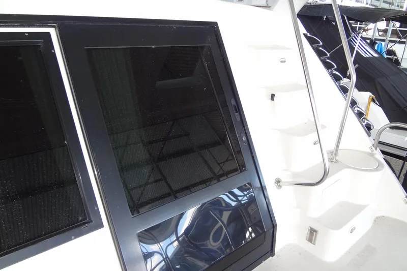 Slide: The Image of 2008 Bluewater 5200 Signature Edition yacht with sleek black windows and white steps. - 31