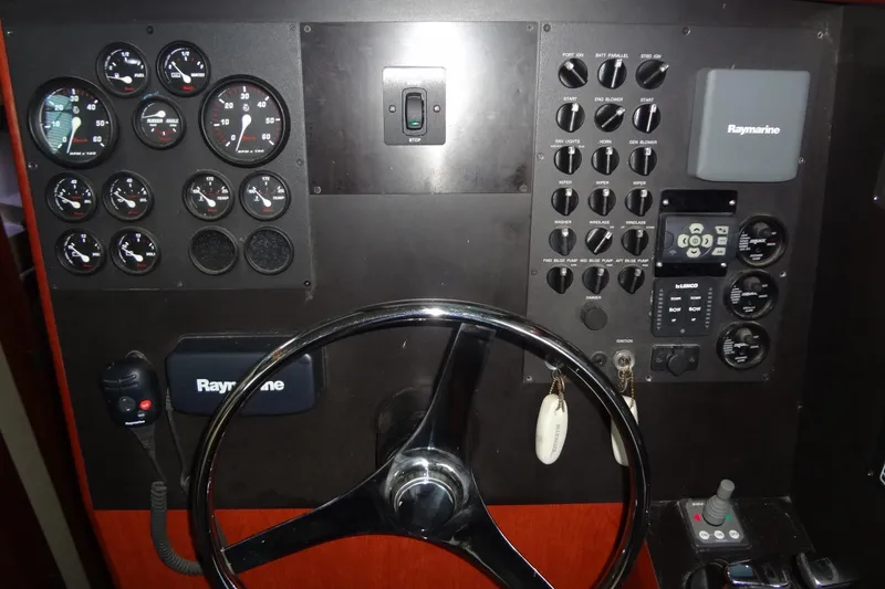 Slide: The Image of Control panel of a 2008 Bluewater 5200 Signature Edition boat with gauges and Raymarine equipment. - 33