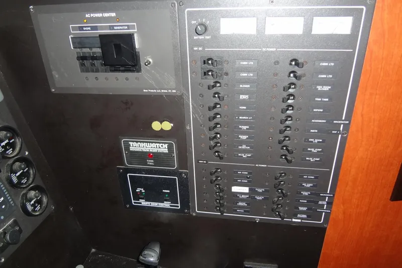 Slide: The Image of Control panel of 2008 Bluewater 5200 Signature Edition boat, featuring AC and DC power switches. - 34