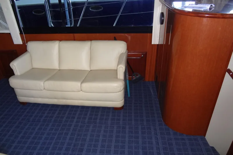 Slide: The Image of Interior of 2008 Bluewater 5200 Signature Edition yacht with cream sofa and wooden cabinetry. - 35