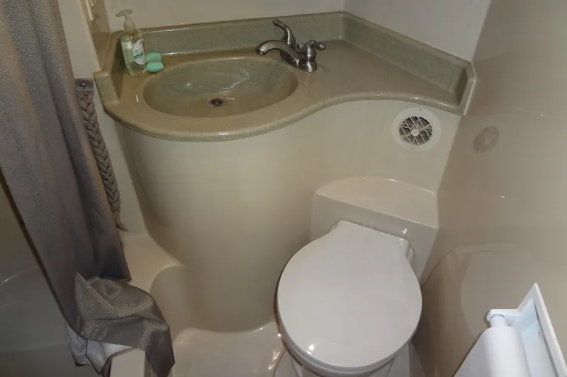 Slide: The Image of Compact bathroom in 2008 Bluewater 5200 Signature Edition yacht, featuring sink and toilet. - 40