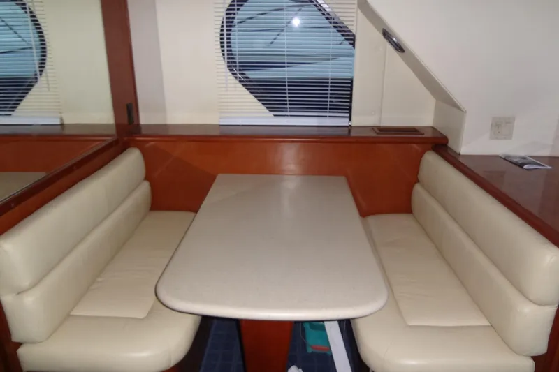 Slide: The Image of 2008 Bluewater 5200 Signature Edition interior with beige seating and table. - 44