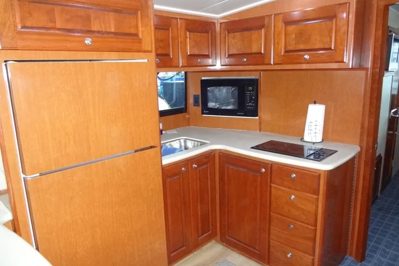 Slide: The Image of Luxurious kitchen in 2008 Bluewater 5200 Signature Edition yacht with wood cabinetry. - 45