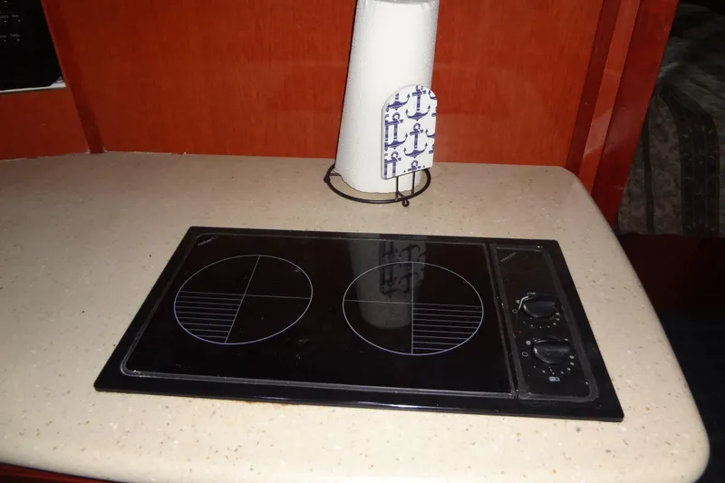 Slide: The Image of 2008 Bluewater 5200 Signature Edition yacht kitchen with electric stovetop and paper towel holder. - 46