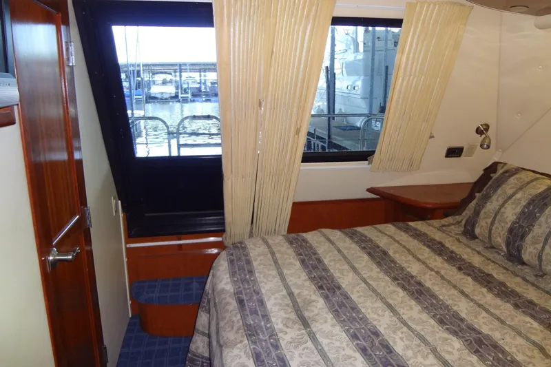 Slide: The Image of Interior of 2008 Bluewater 5200 Signature Edition yacht bedroom with window view. - 50