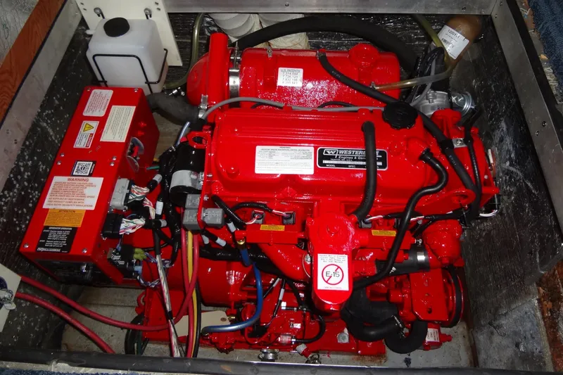 Slide: The Image of Engine compartment of a 2008 Bluewater 5200 Signature Edition with red Westerbeke generator. - 58
